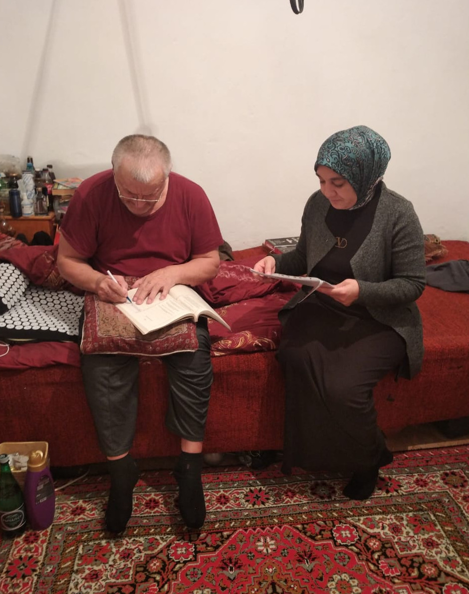 Подопечный Исаковой С. расписывается в дневнике социального работника.